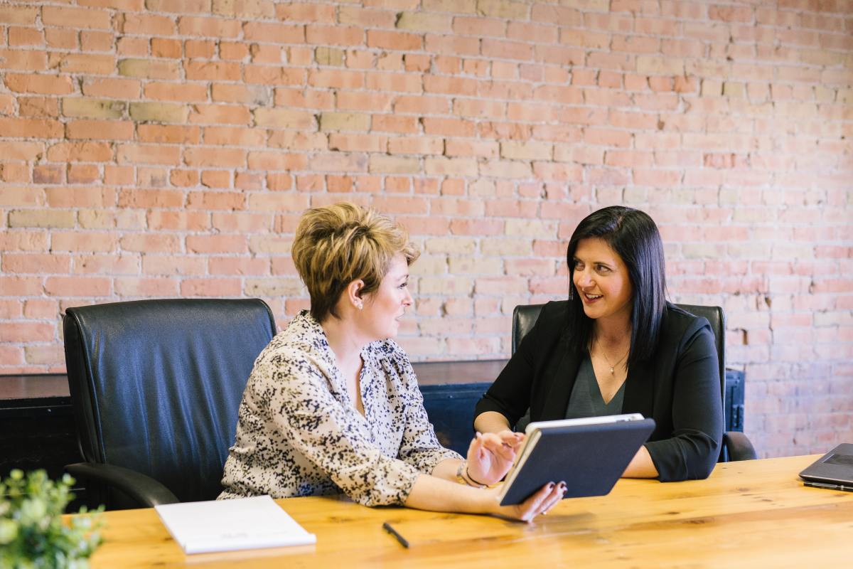 Two women sitting at a desk